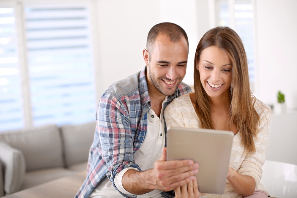 Young couple at home websurfing on internet.jpeg