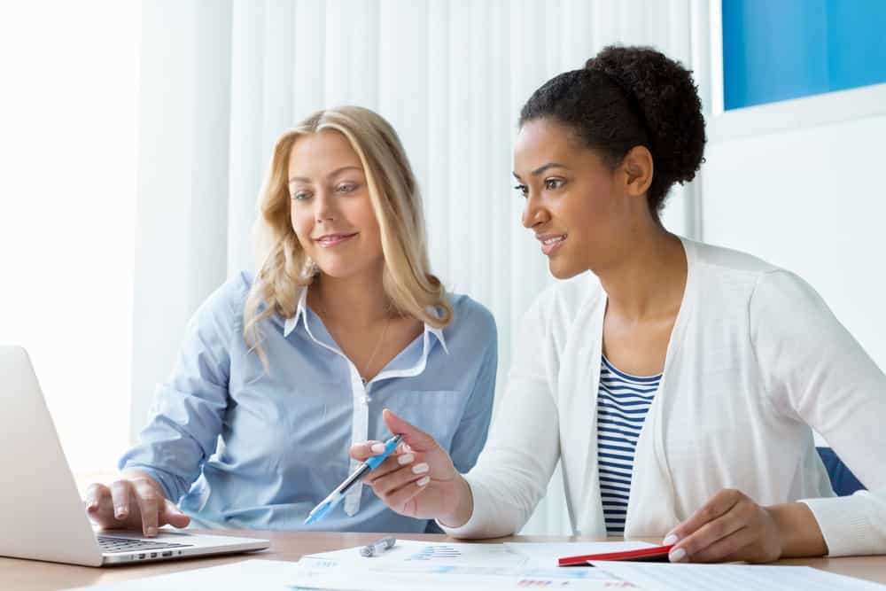 Two women working together in office