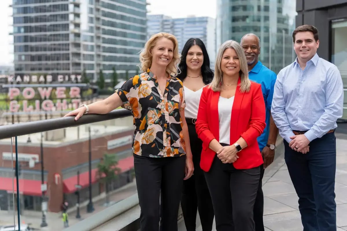 Axcet HR Solutions, one of the best peo companies, team photo outside near the Kansas City Power and Light sign