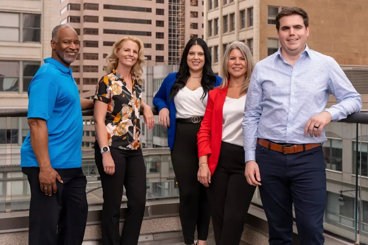 The team at Axcet discussing why delaying offering better employee benefits packages can cost businesses big