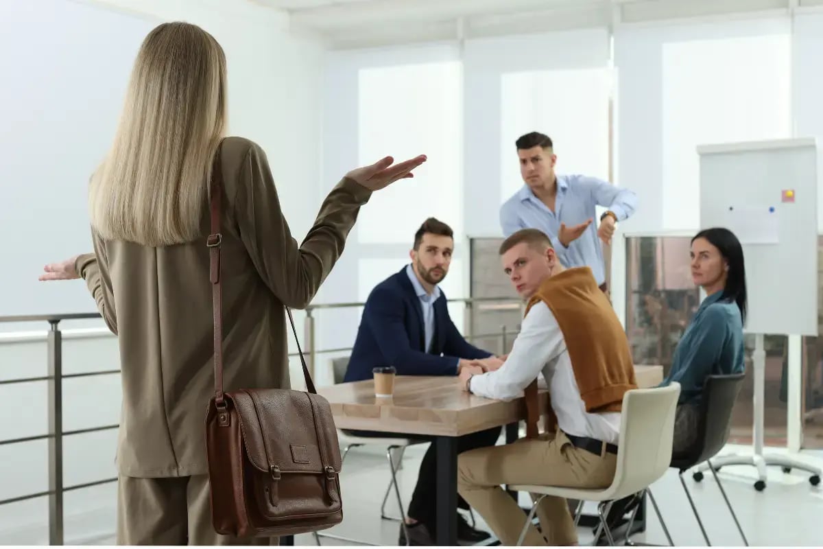 Employees late for work entering an office building, representing employee tardiness and attendance management challenges