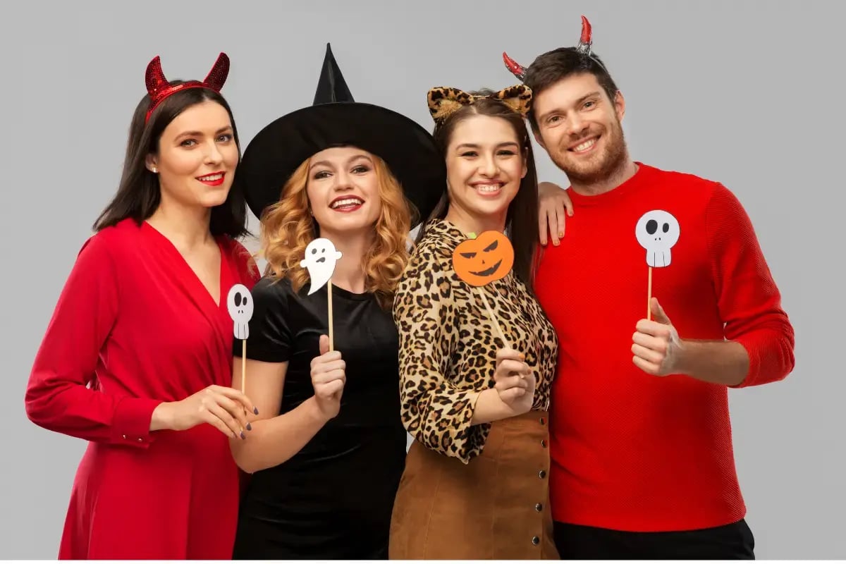 Office employees in Halloween costumes enjoying healthy Halloween snacks and participating in fitness activities, supporting a health-conscious workplace.