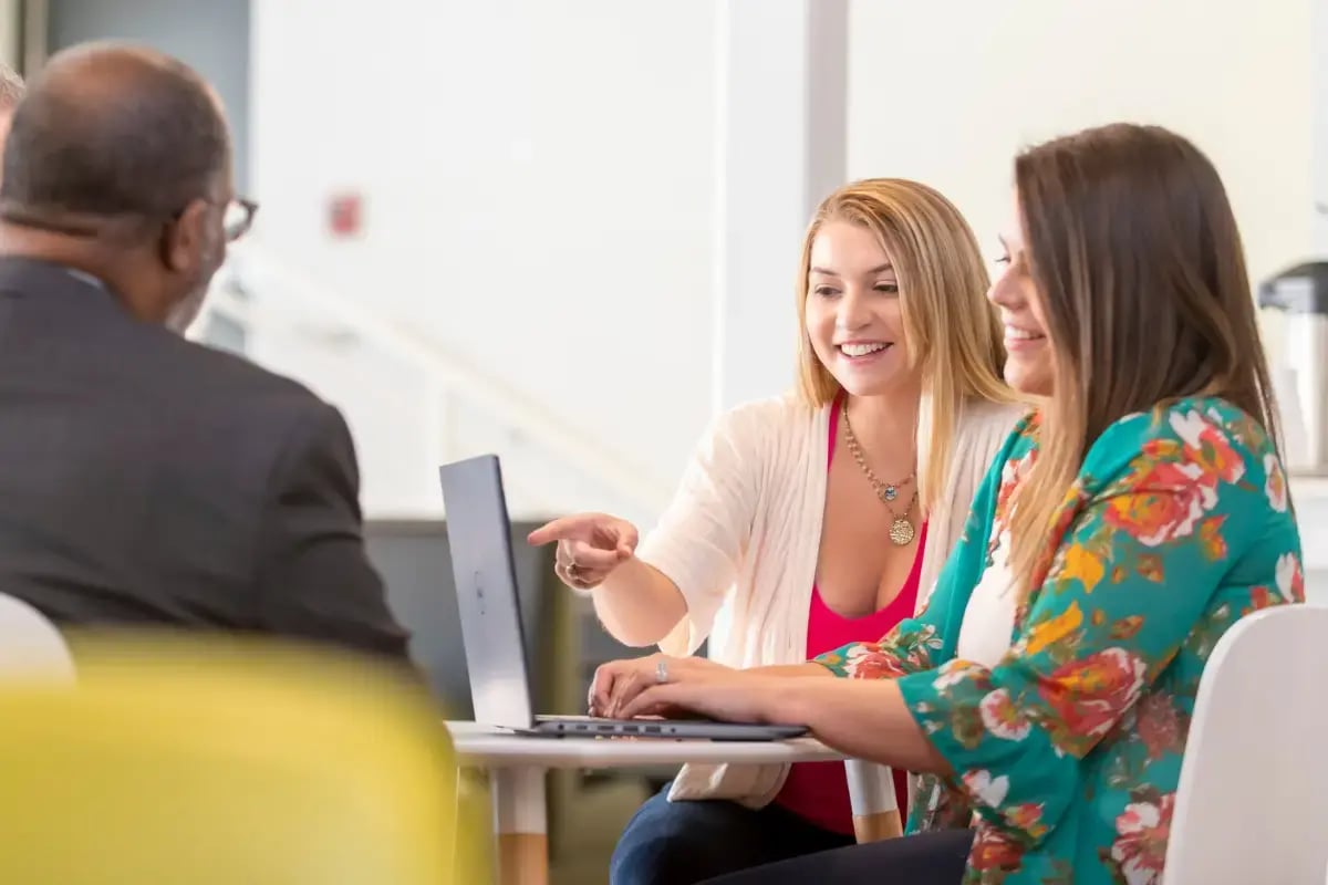 Business owner learning how to compare health insurance plans for small businesses by reviewing coverage options and costs.