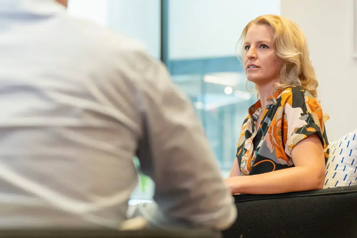 A professional woman leading a performance meeting to address poor employee performance issues.