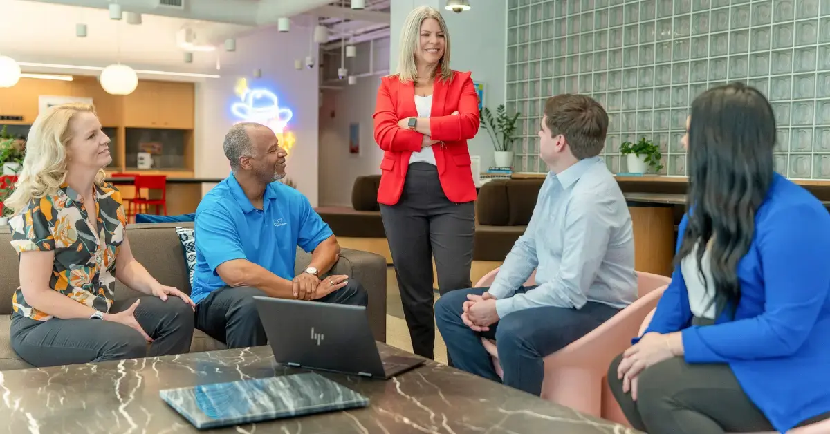 Axcet HR Director meeting with her team to discuss workplace dress code violations