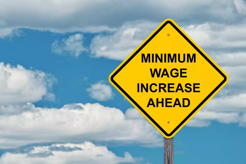 traffic sign stating minimum wage inrease ahead